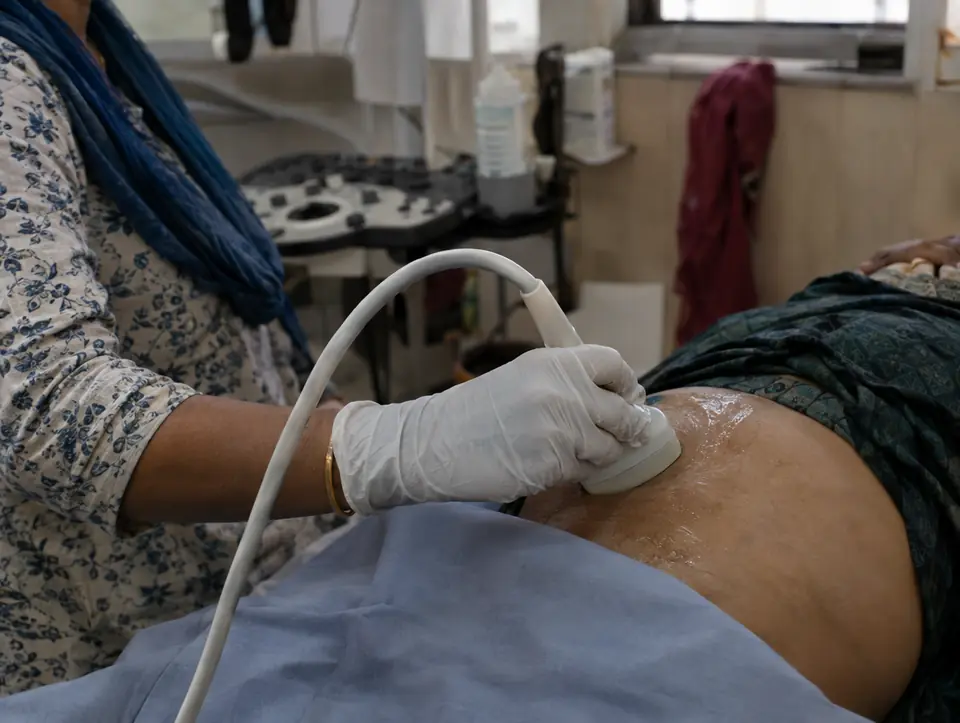 An ultrasound probe in a gloved hand